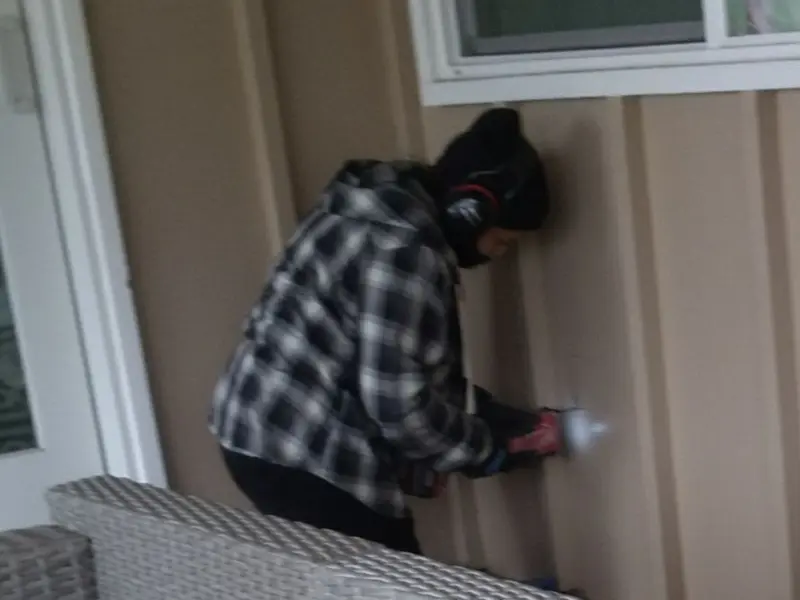 Professional electrician installing an exterior outlet in Reston